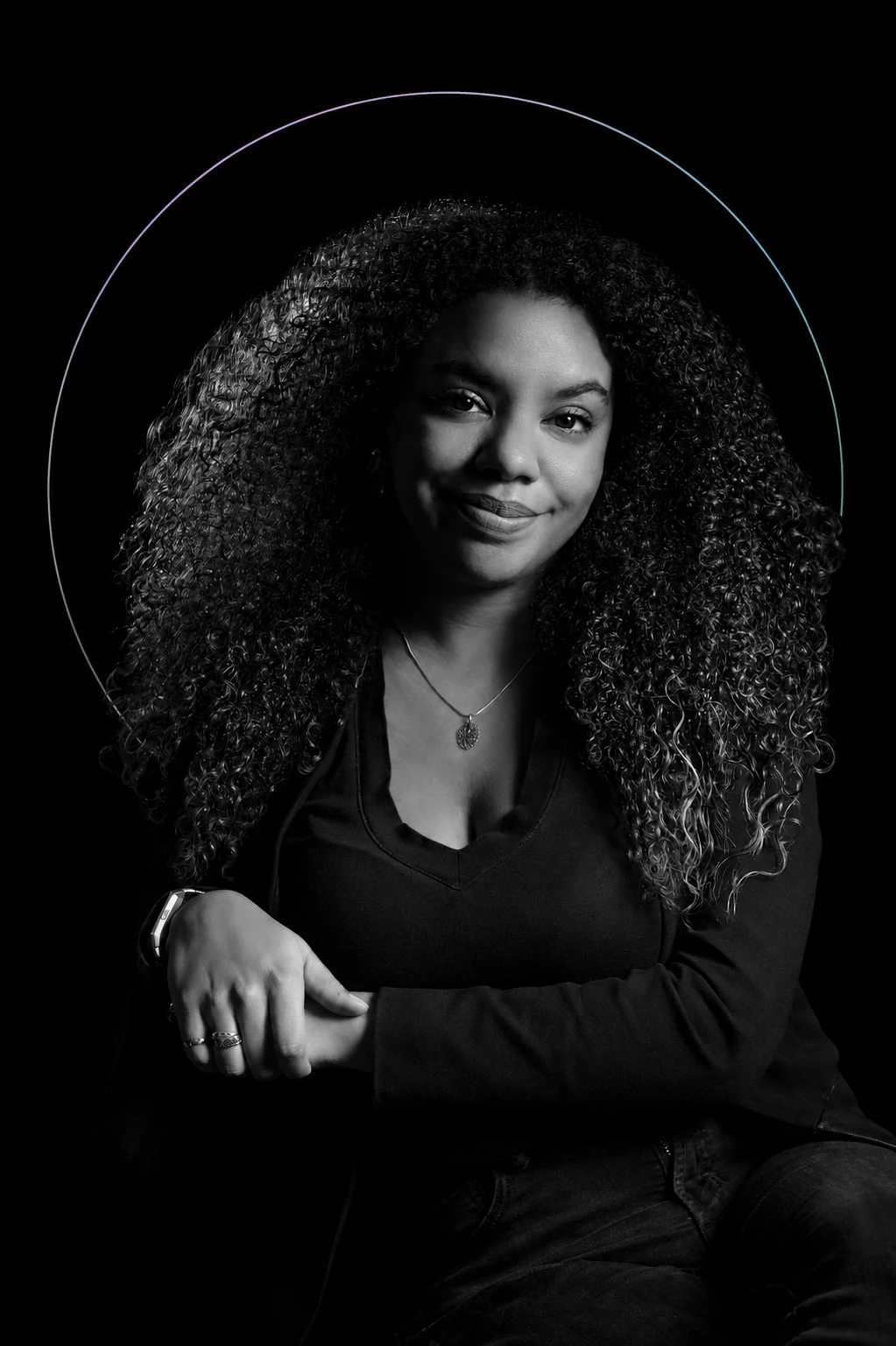 Black-and-white portrait of Fadjiah Collin-Mazile against matte black, framed by a subtle arc